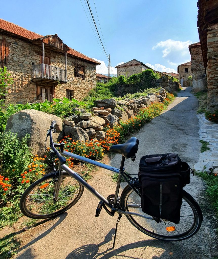 bike with century old houses in the background in prespa area