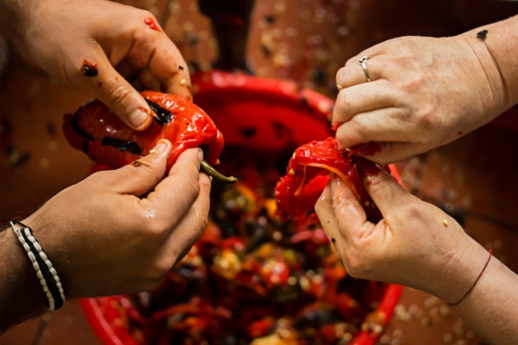 pealing red meaty peppers with hands